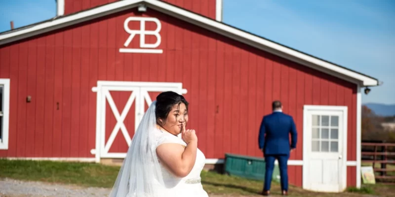 bride and red barn